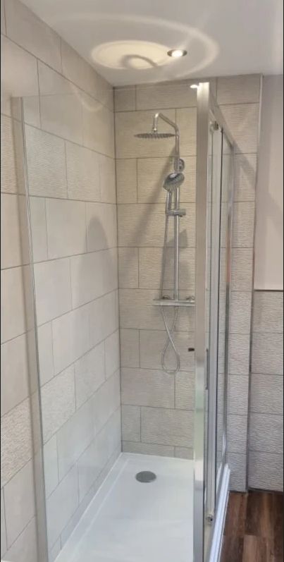Fully tiled shower enclosure with rainfall shower head